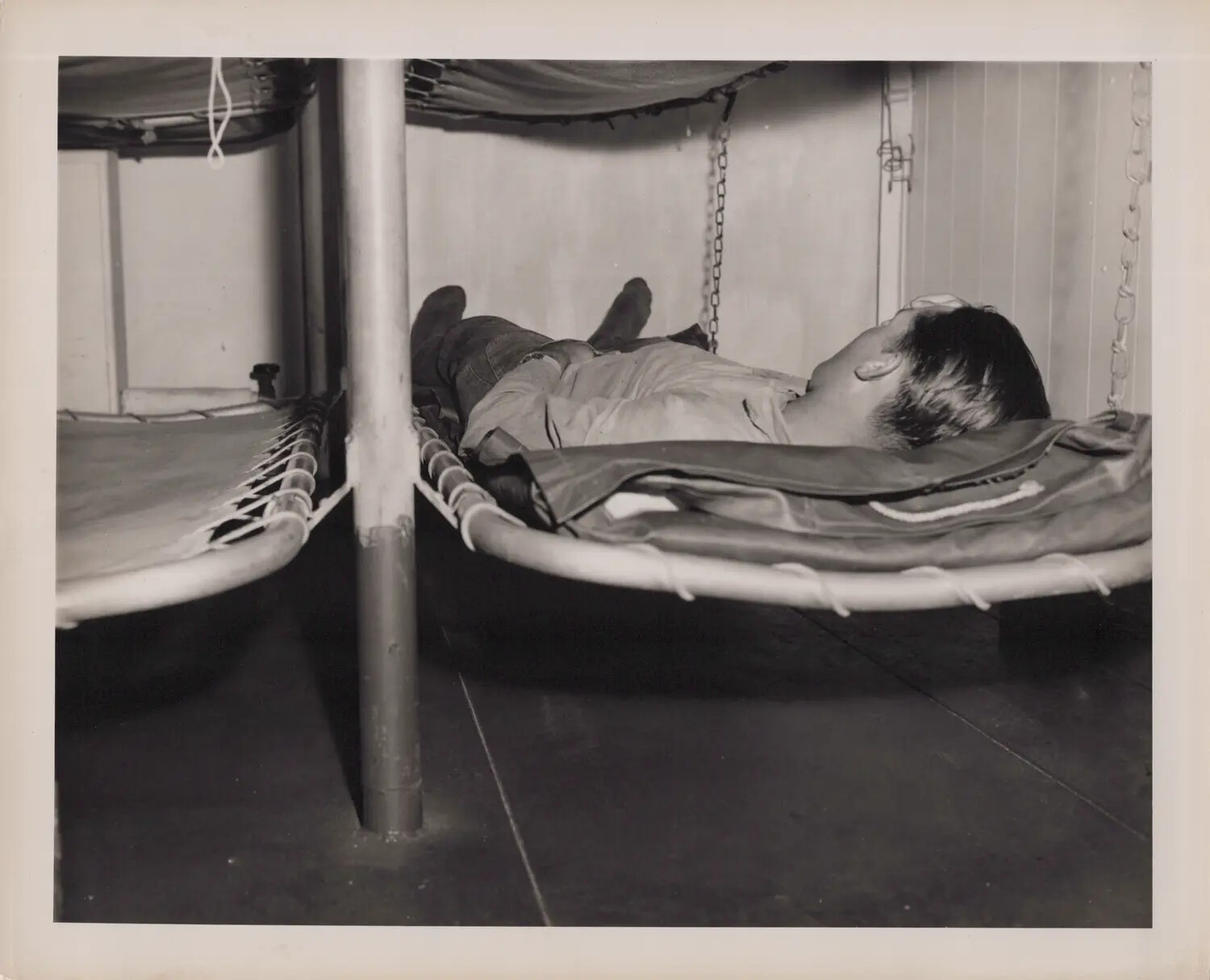 Sailor Asleep in Berthing Compartment, U.S. Navy Vessel, World War II