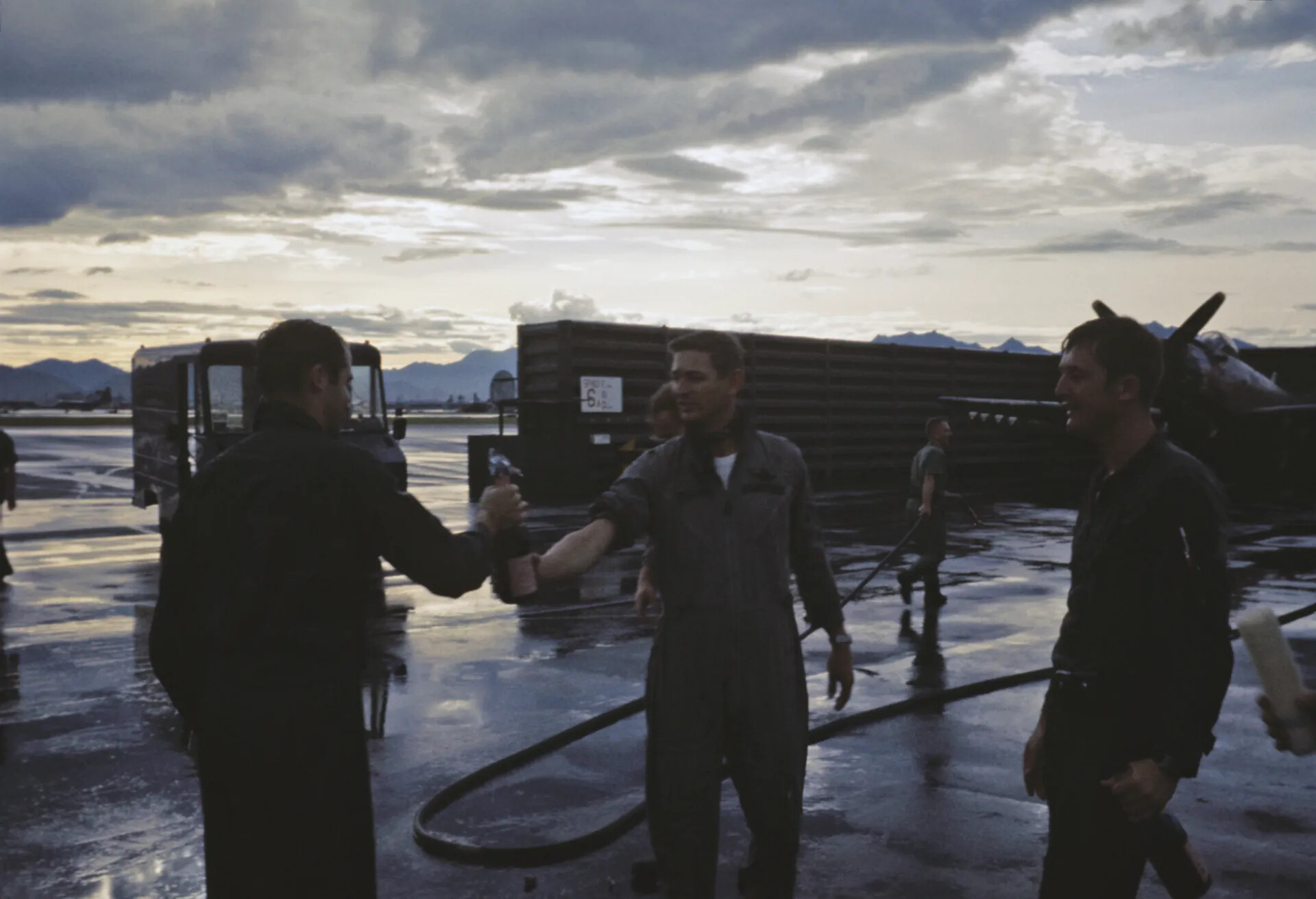 Airmen Sharing a Celebratory Toast on the Flight Line at Dusk