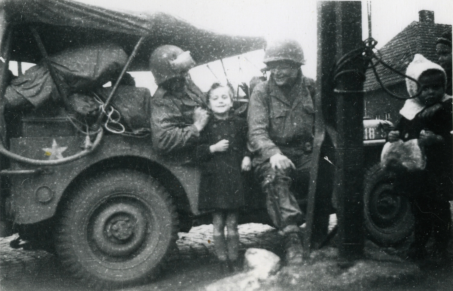 American Soldiers with Local Children Beside Military Truck, European Village