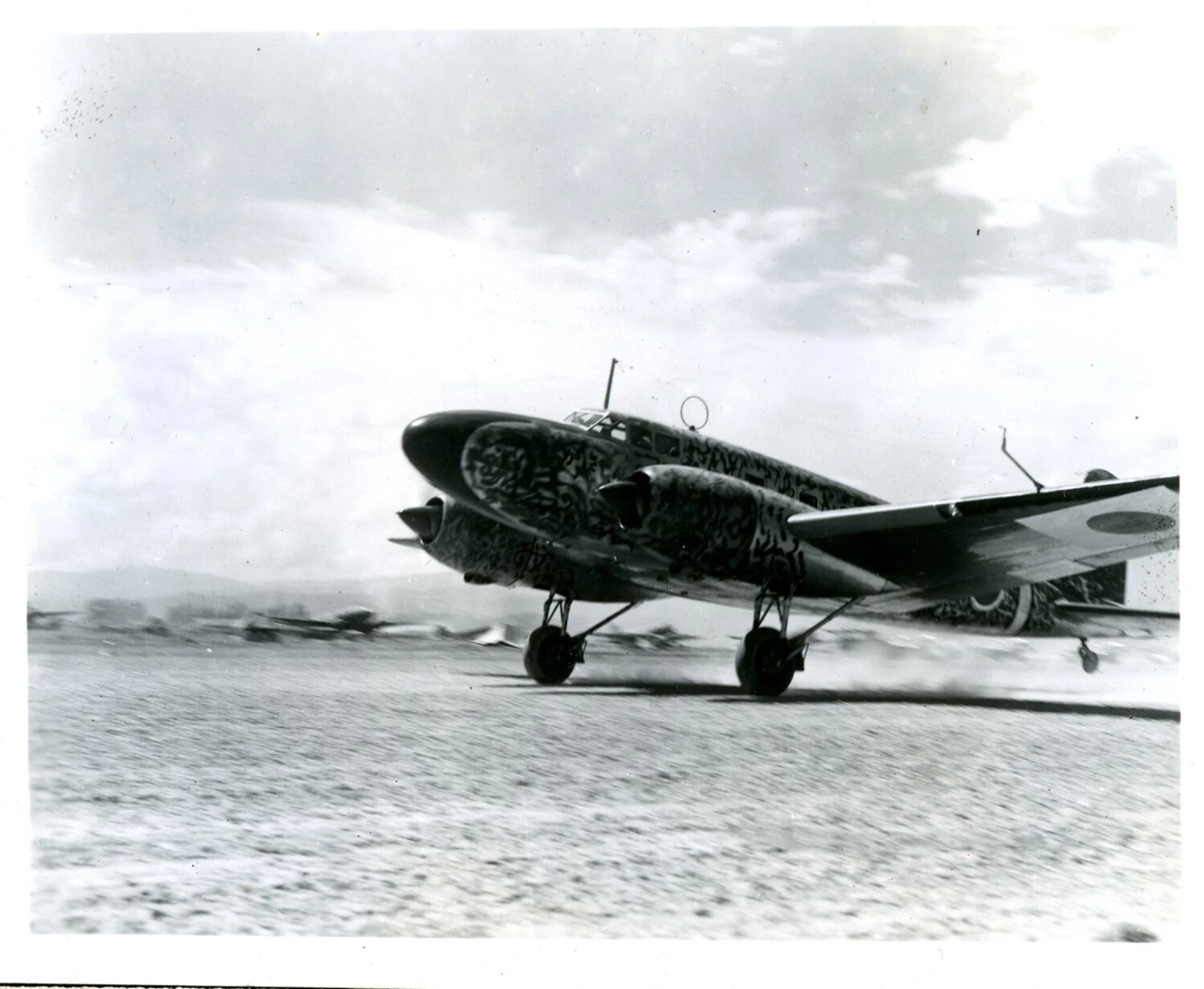 Captured Japanese Twin-Engine Aircraft Taxiing on Dirt Airstrip, CBI Theater, WWII