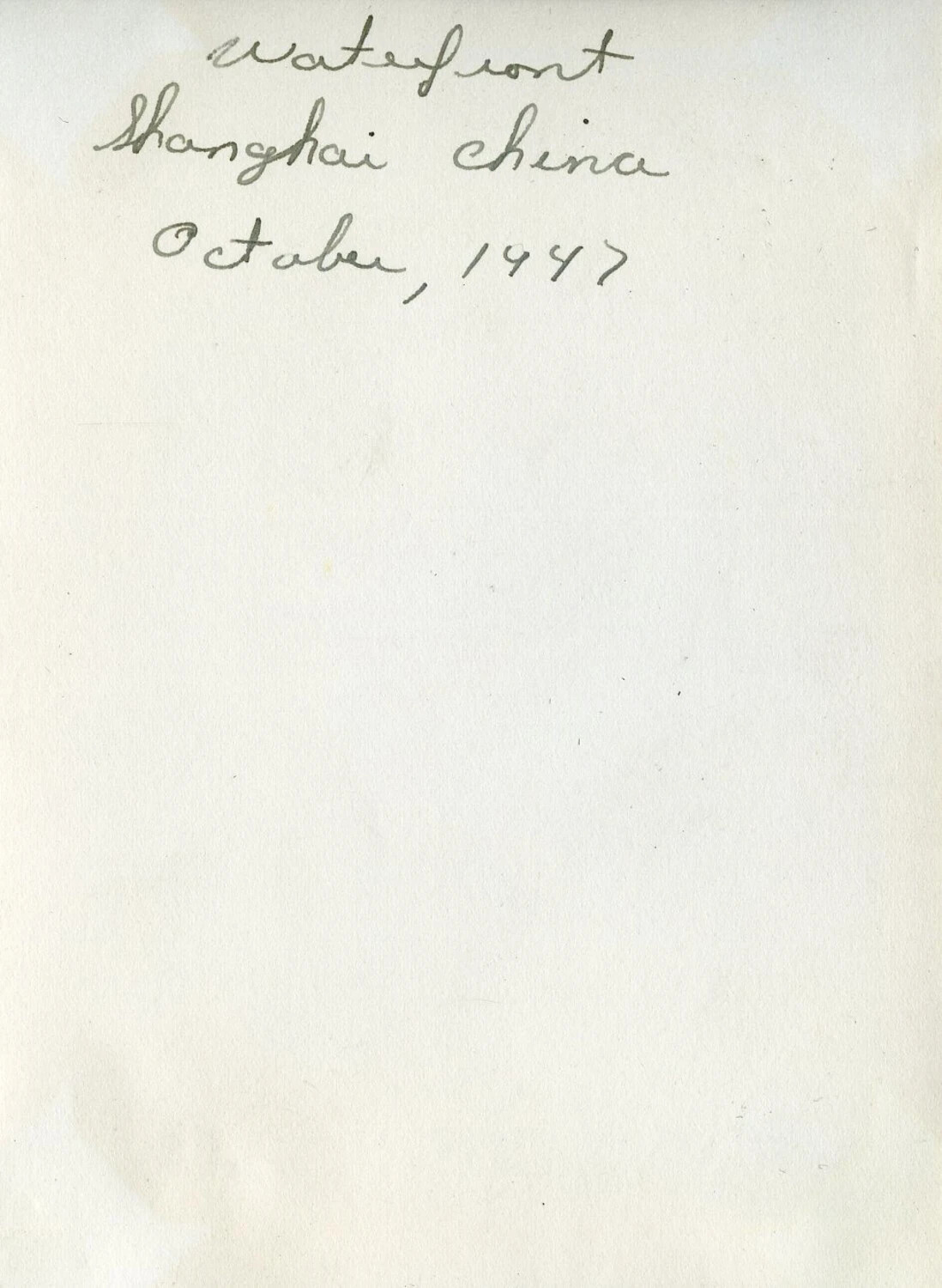 Album Page with Handwritten Caption 'Waterfront, Shanghai China, October 1947' — VR-6 Naval Air Transport Squadron Album, Agana, Guam