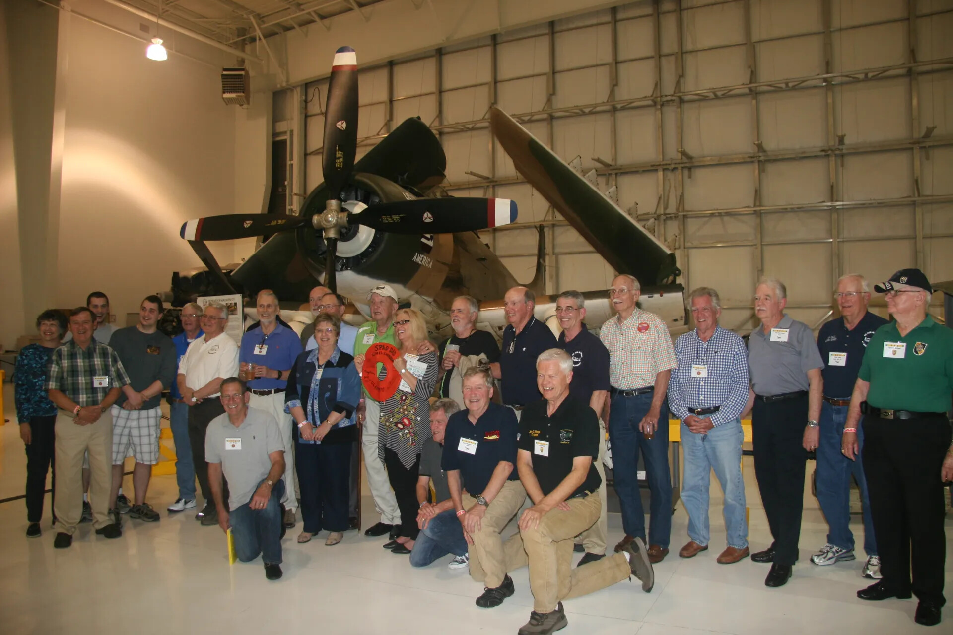 Full Group Photo Beneath A-1 Skyraider 'AMERICA', Aviation Museum Hangar