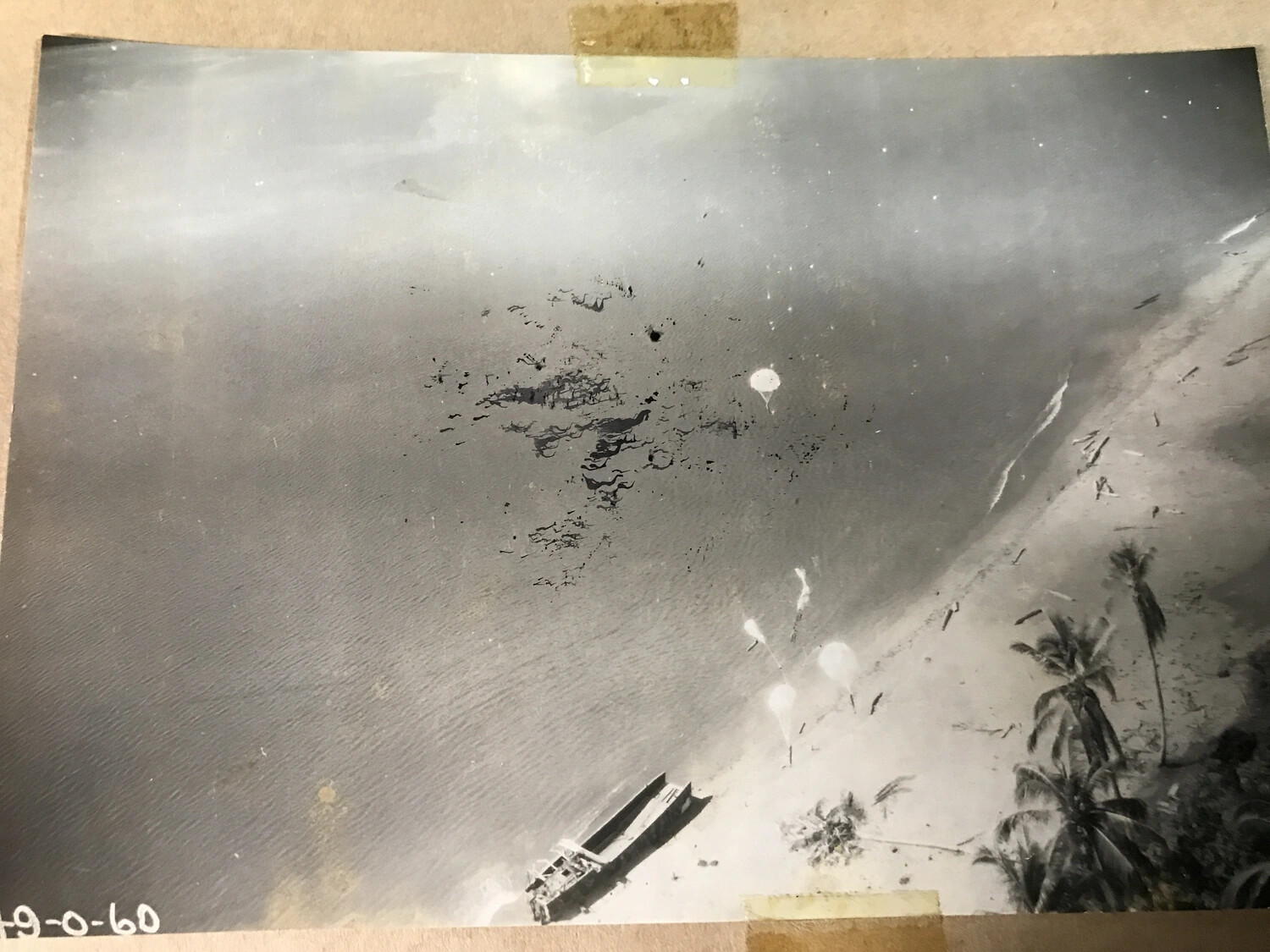 Strafing Attack on Beached Vessel Along Tropical Coastline, Pacific Theater