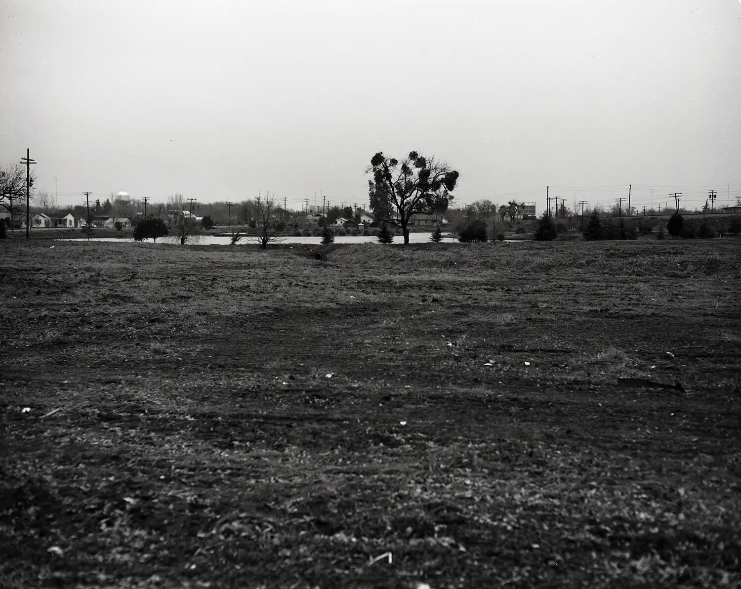 Cleared Field and Adjacent Neighborhood, Site of National Guard Facility Development