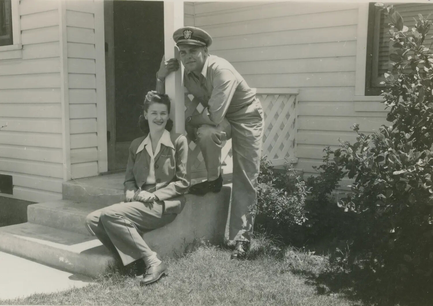Portrait of a Uniformed Serviceman and a Woman on a Residential Porch, Likely Edward P. McAleer, WWII Era