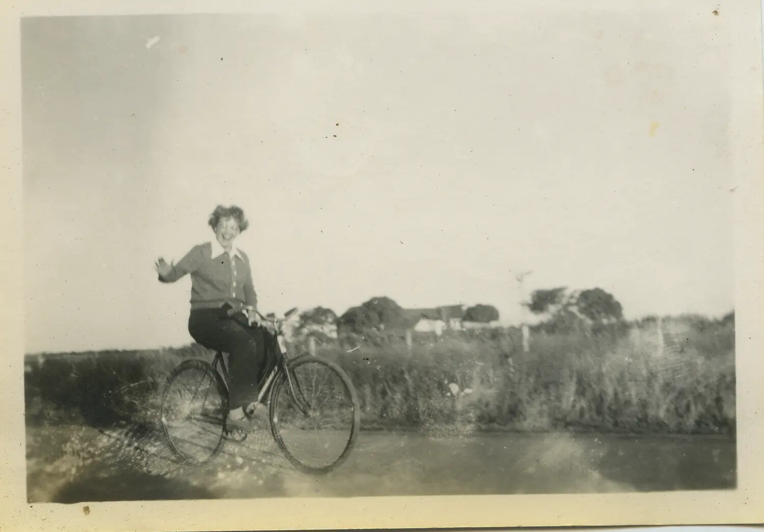 Woman Waving on a Bicycle, Countryside Road (Personal Snapshot)