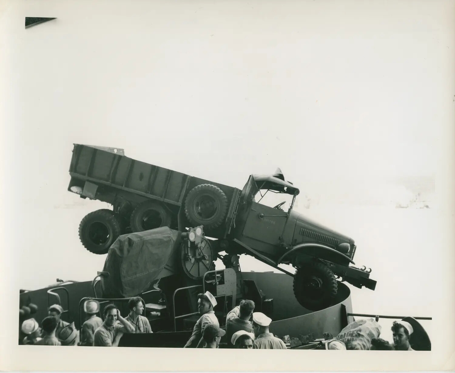 GMC CCKW Cargo Truck Overturned on 5-inch Gun Mount Aboard USS Petrof Bay (CVE-80), WWII