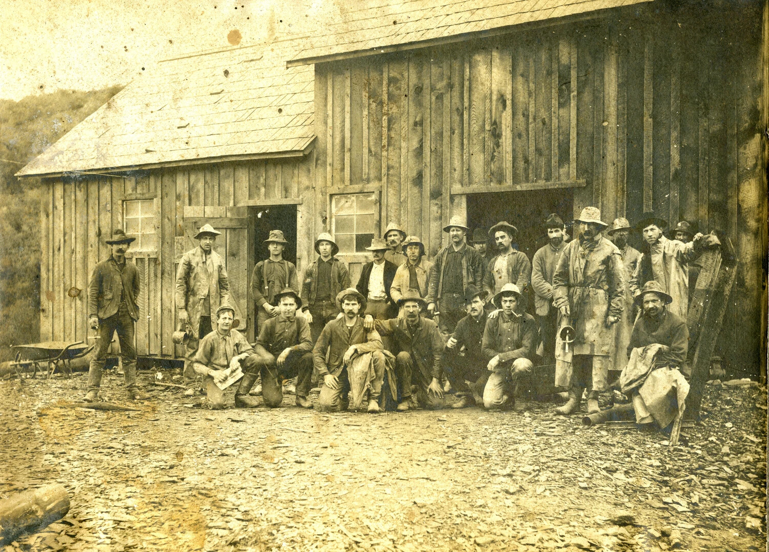 Group Portrait of an American Logging or Mining Crew Outside a Timber Building, c. 1890s-1910s