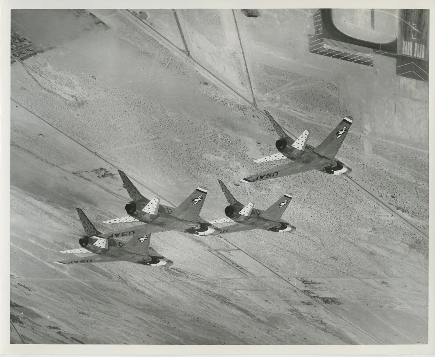 Overhead View of Thunderbirds Formation with 'USAF' Wing Markings Over Airfield