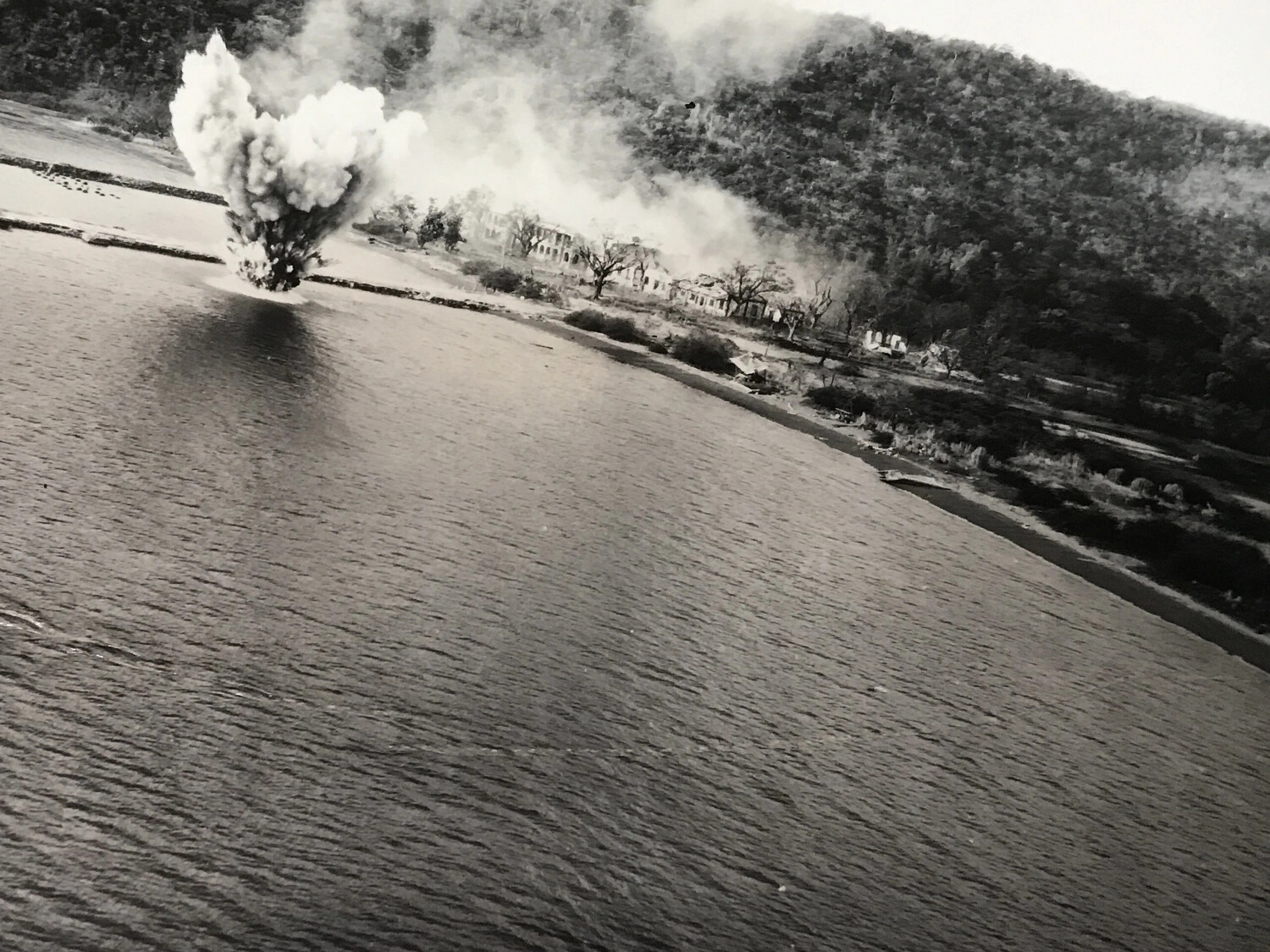 Aerial Strike Photo: Bomb Burst Near Coastal Installation, Pacific Theater
