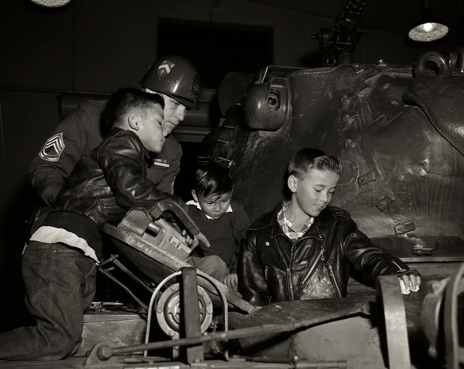 National Guard Sergeant and Children Examining Tank Turret Details During Open House