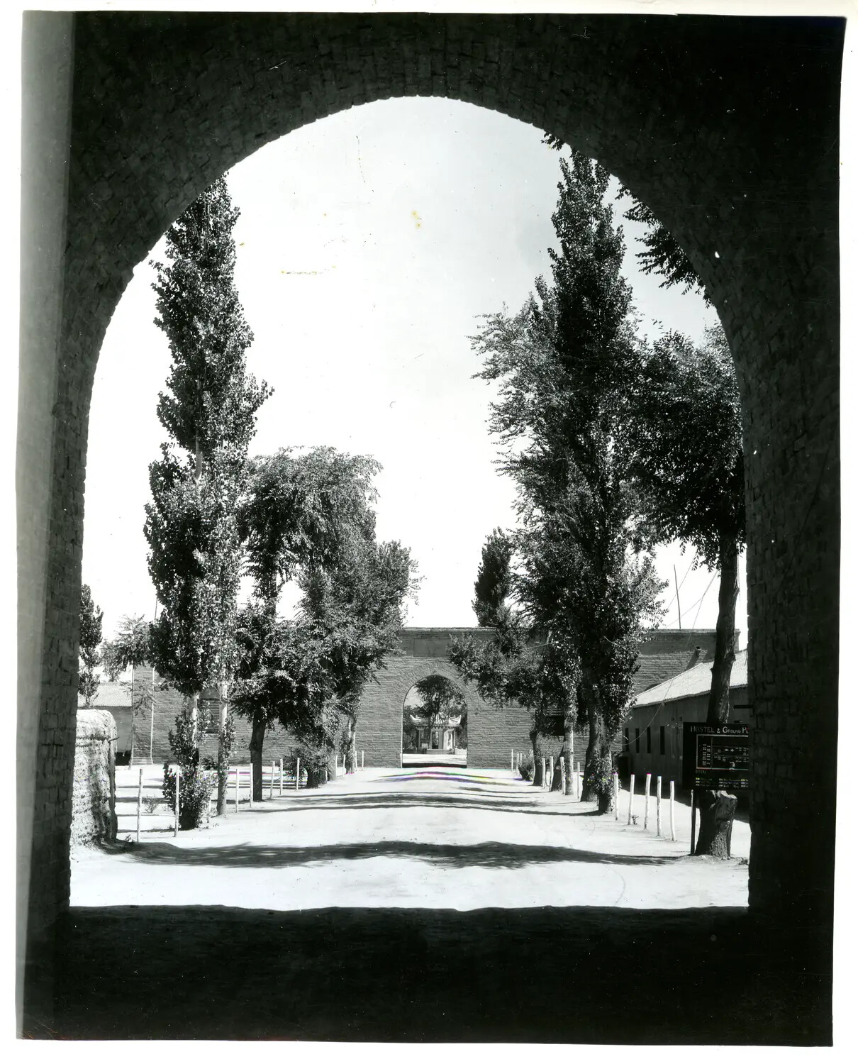 View Through a City Wall Arch Toward a Hostel Compound, China-Burma-India Theater, WWII