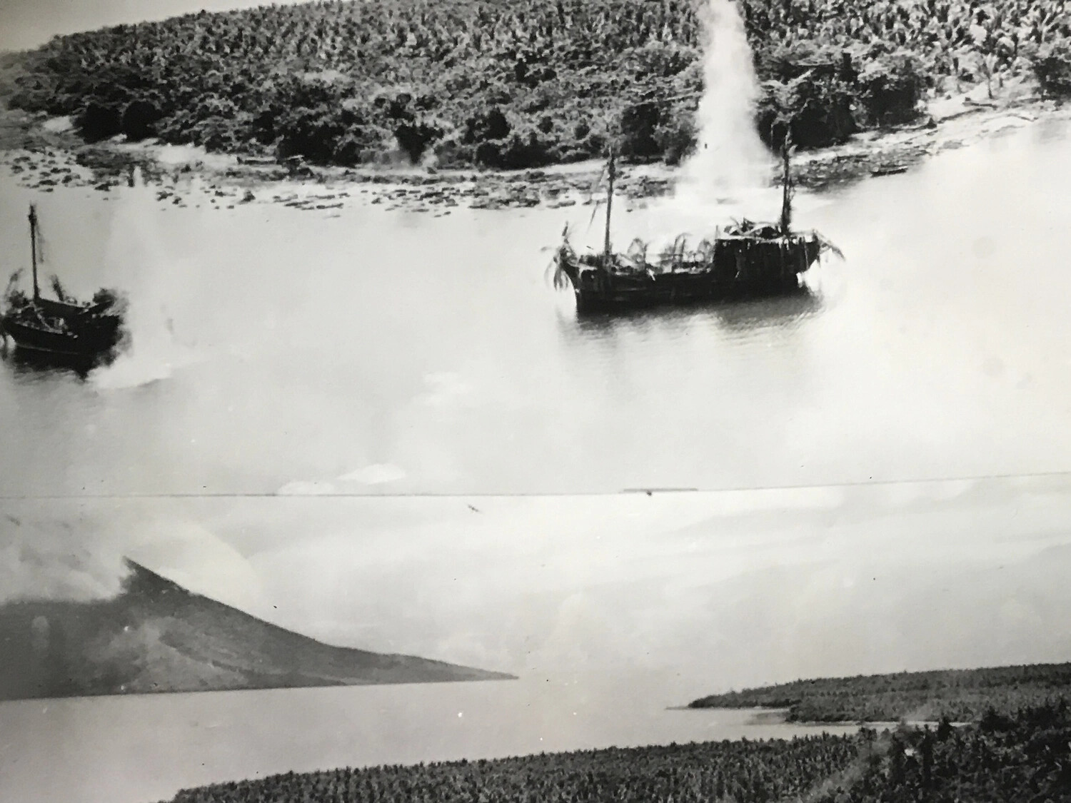 Aerial Strike Sequence Photograph: Attack on Camouflaged Barges with Volcanic Coastline Backdrop