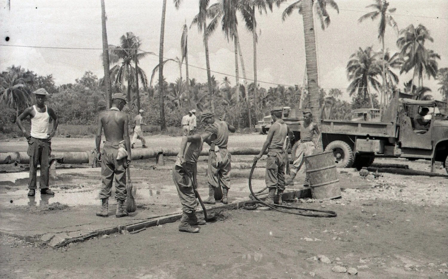 Engineering Crew Working with Water Hoses and Drum at Concrete Site, Luzon, Philippines, WWII