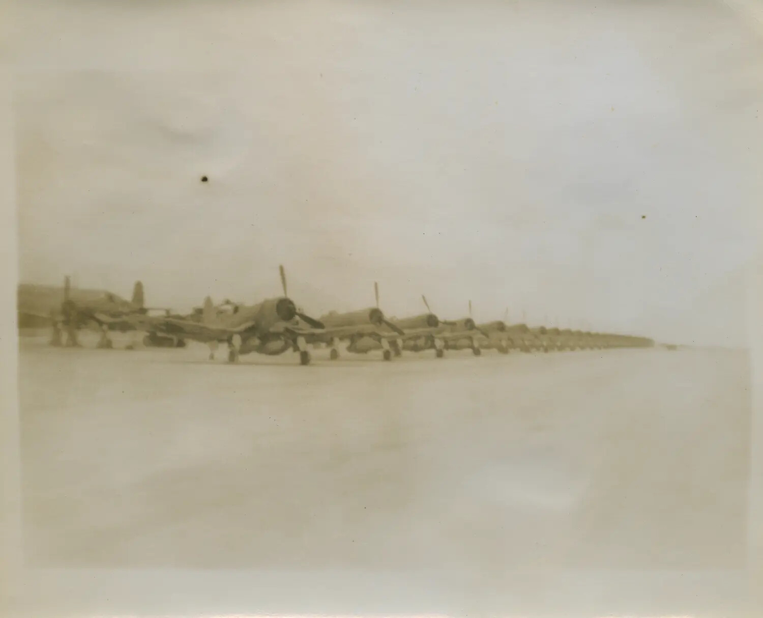 Row of Single-Engine Radial Fighter Aircraft Parked on Airfield Ramp