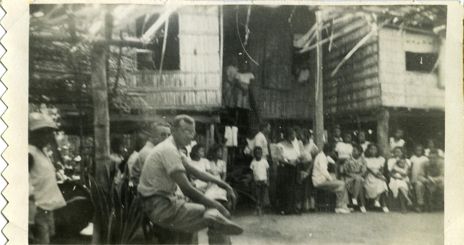 American Serviceman Among Villagers at a Stilt-House Settlement, Pacific Theater, World War II Era