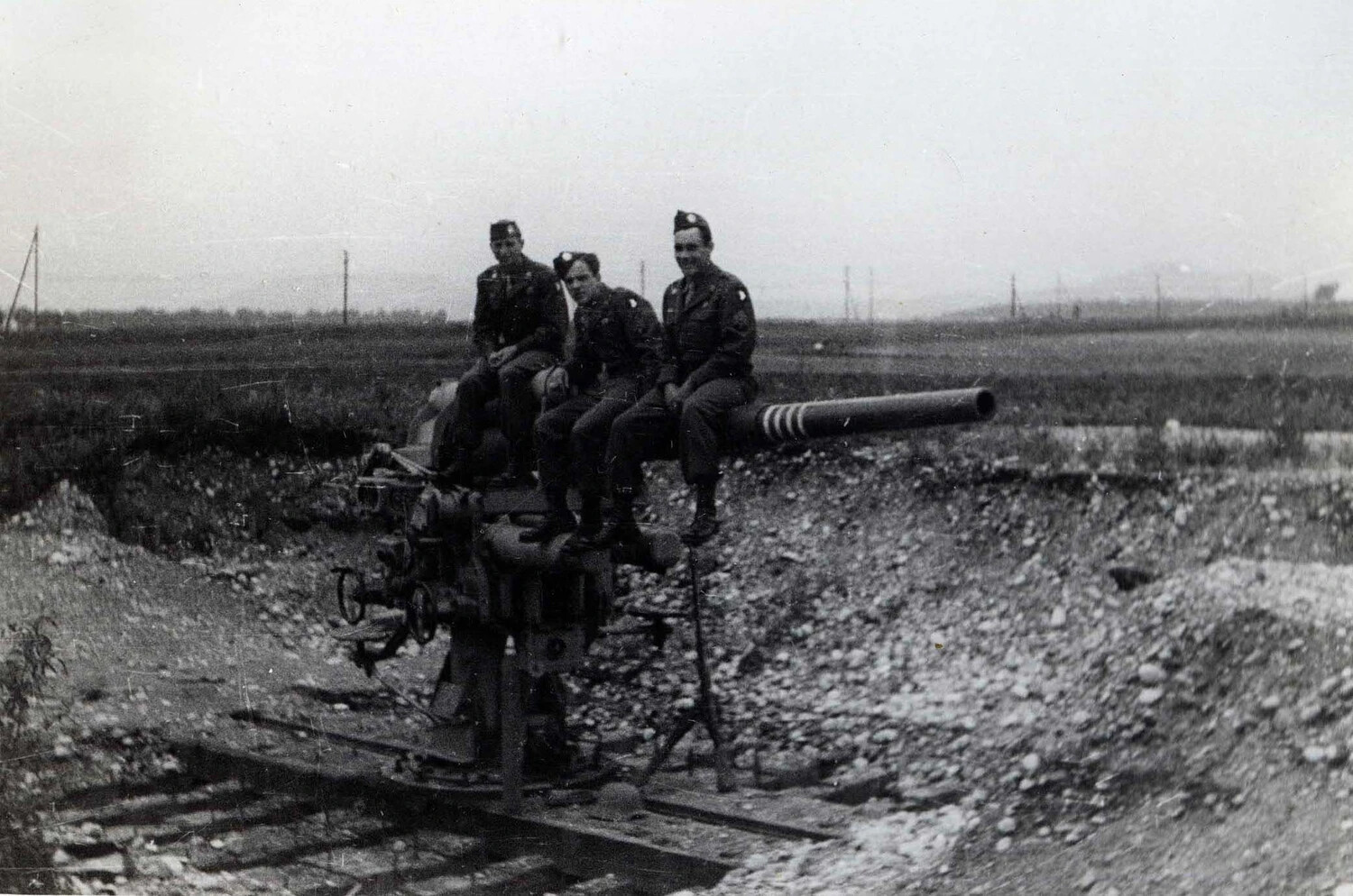 American Soldiers Posing on a Captured German 88mm Gun Emplacement, WWII European Theater - 101st Airborne Collection