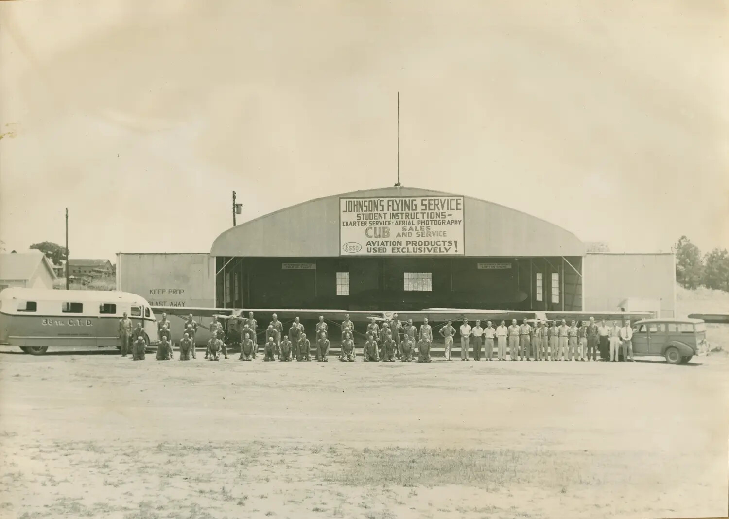 Group Portrait of Aviation Cadets and Staff, 38th College Training Detachment, Johnson's Flying Service Hangar, World War II Era