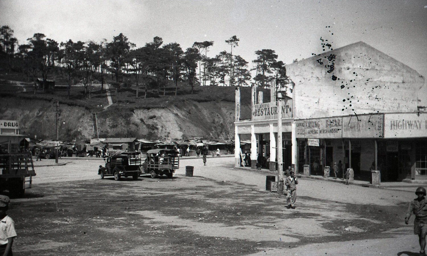 Town Plaza with Military Vehicles and Commercial Row, Luzon, Philippines, WWII Era