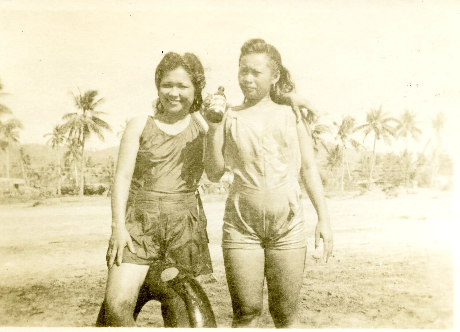 Two Young Women in Bathing Attire, Palm-Lined Coastal Setting, Pacific Theater, WWII Era