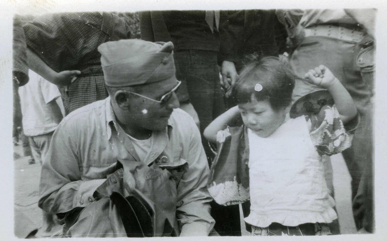 American Serviceman with Japanese Child in Crowded Street Scene, Occupied Japan