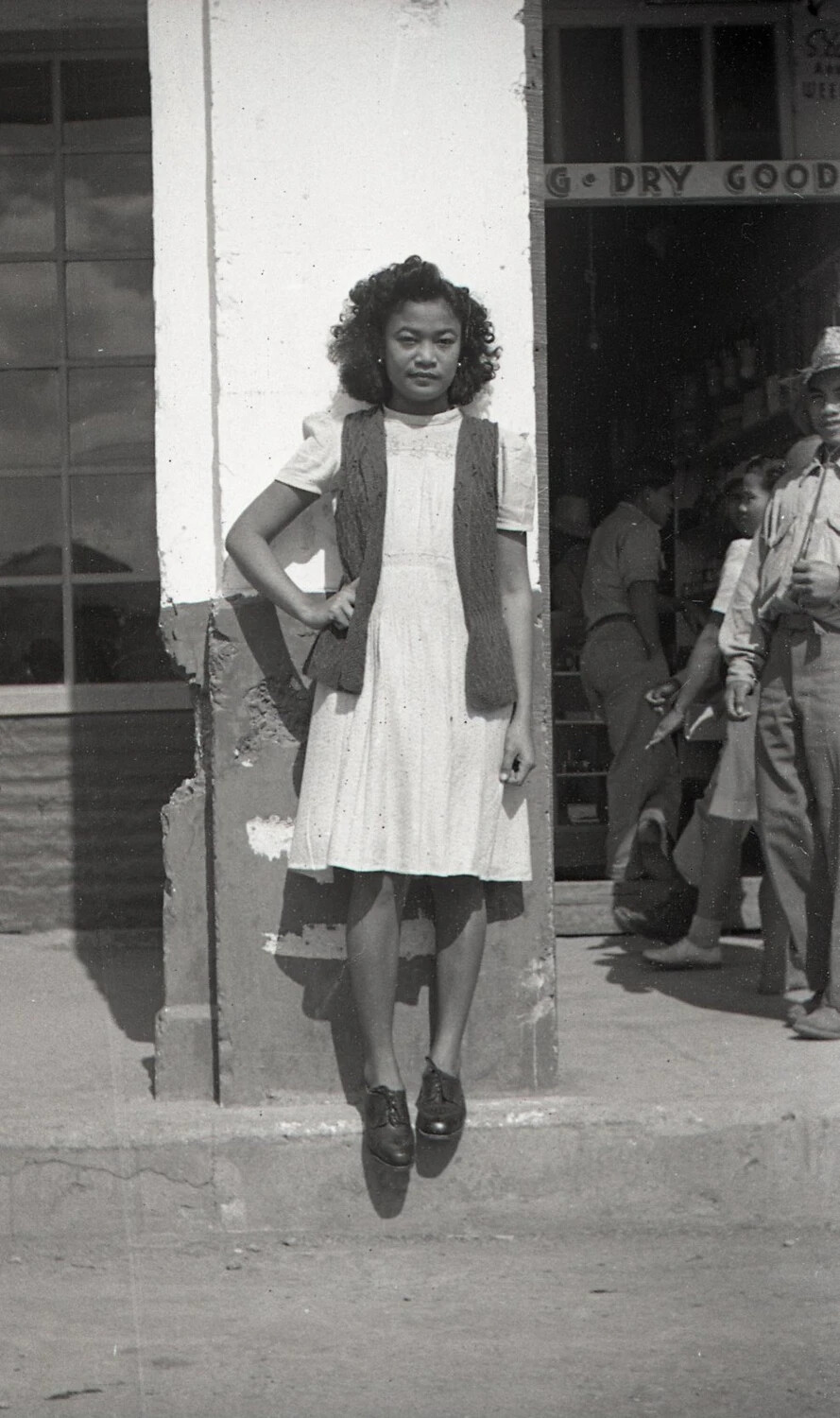 Filipino Woman Photographed Mid-Jump Outside Dry Goods Store, Luzon, Philippines, WWII Era