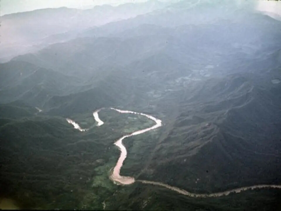 Aerial View of Winding River Through Vietnamese Highland Terrain