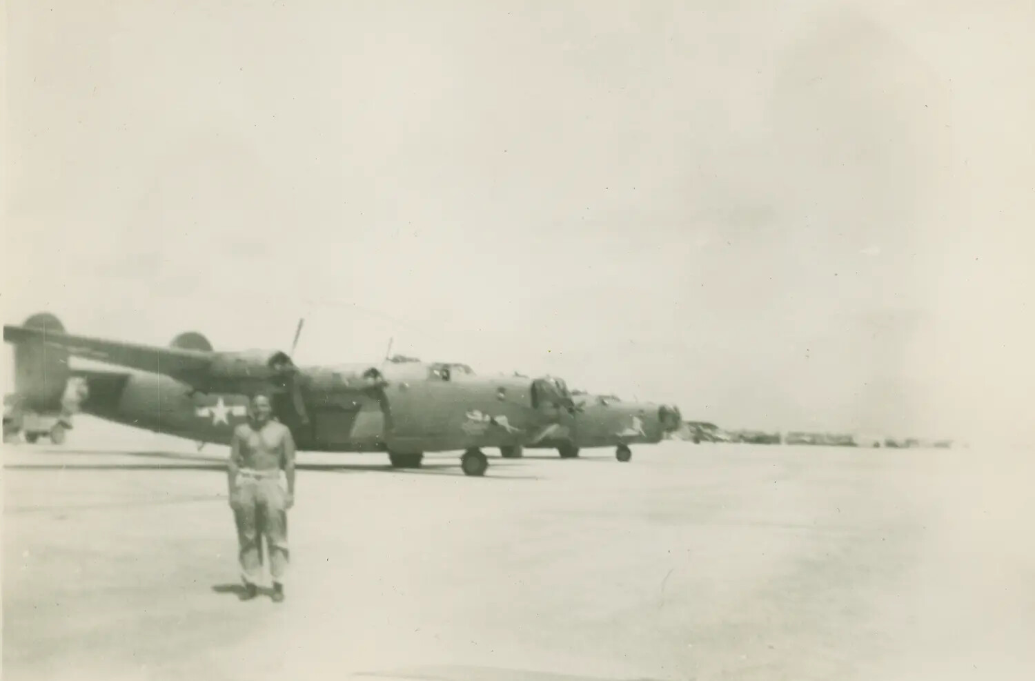 B-24 Liberator Bombers on Airfield Ramp with Serviceman, McAleer Collection, World War II