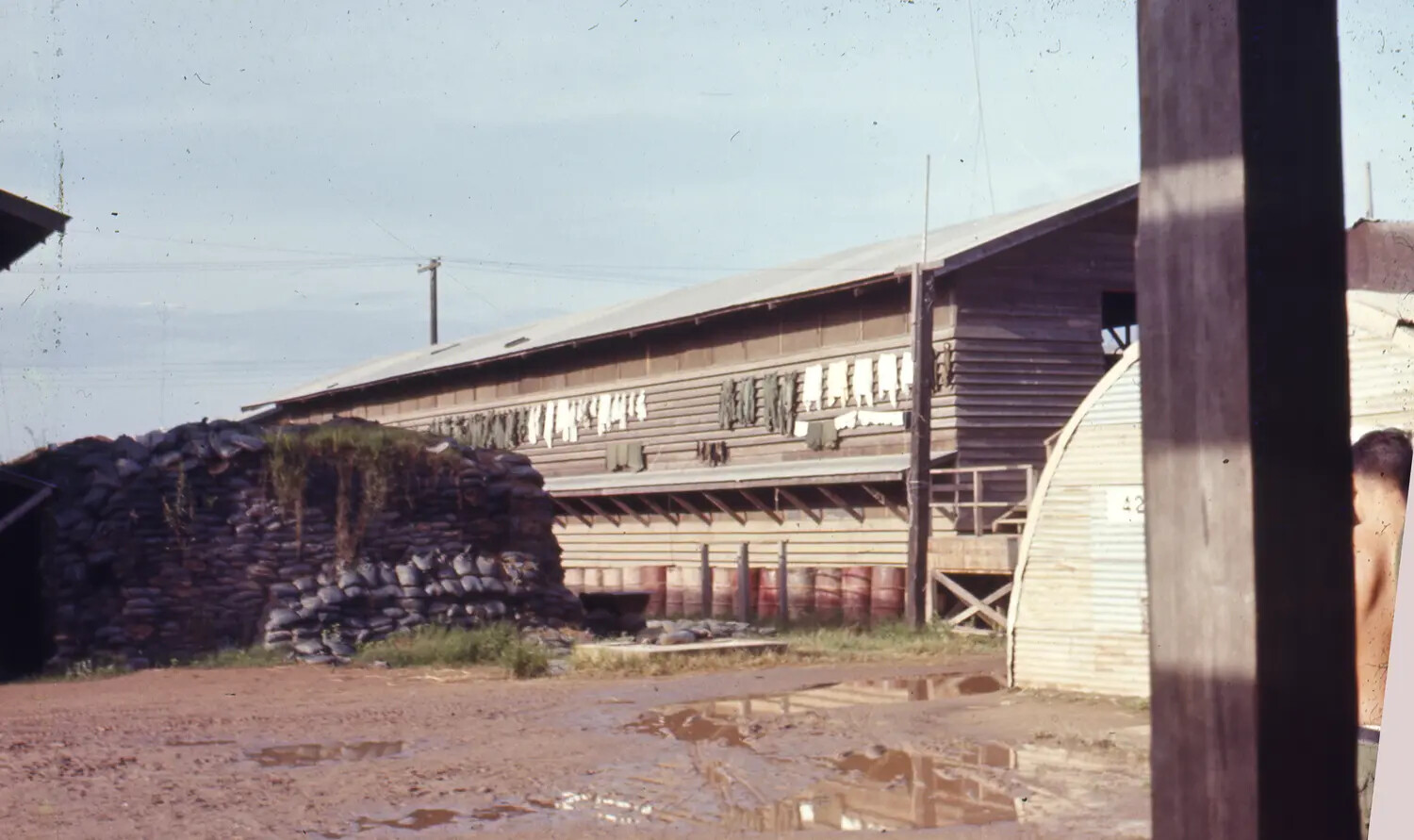 Barracks, Sandbag Bunker, and Quonset Hut at U.S. Base Camp, Vietnam War Era