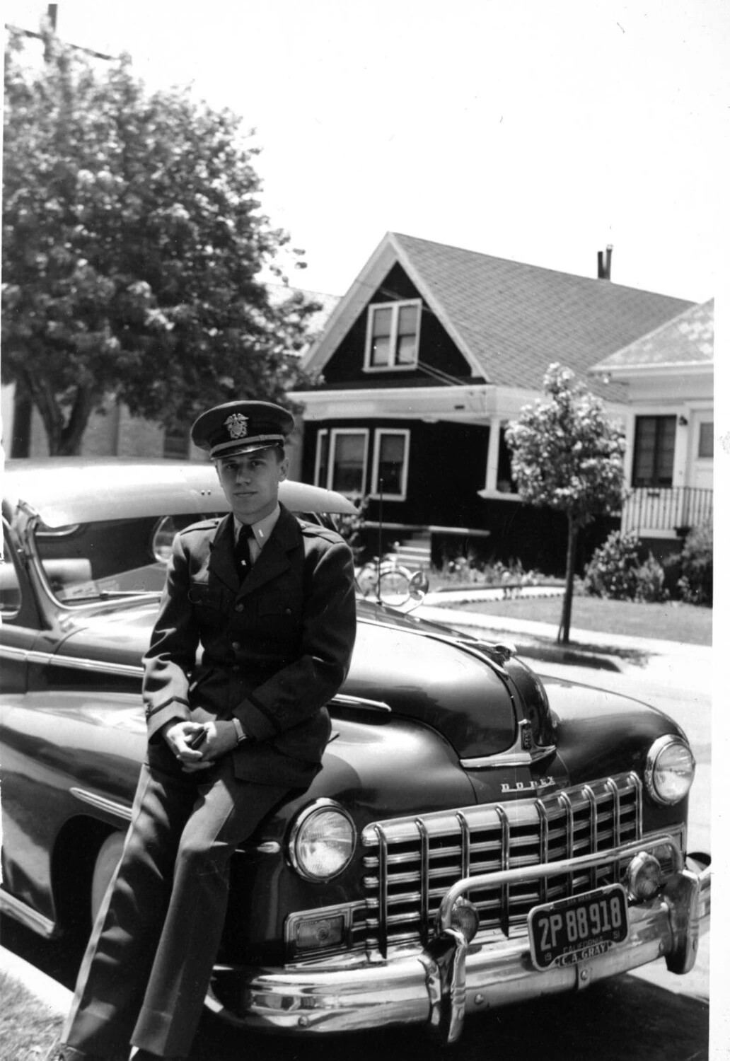 Naval Officer Posed on Automobile Hood, Residential Street, circa 1950-51