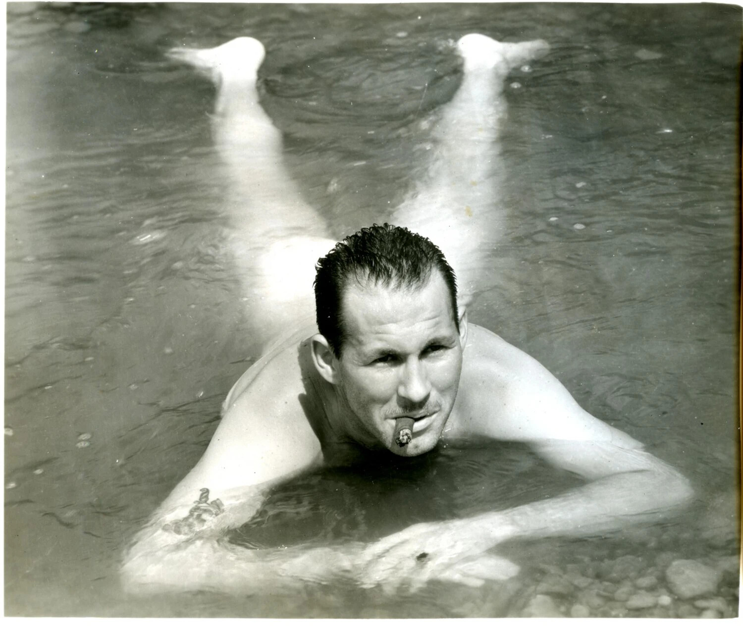 Serviceman Relaxing in River with Cigar, CBI Theater, WWII Era