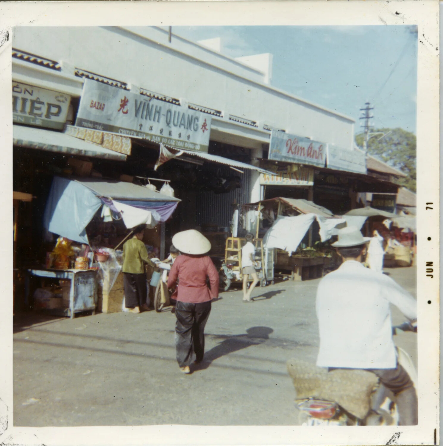 Market Street Scene with Storefront Signage 'Vinh-Quang' and 'Kim Anh,' Vietnam, June 1971