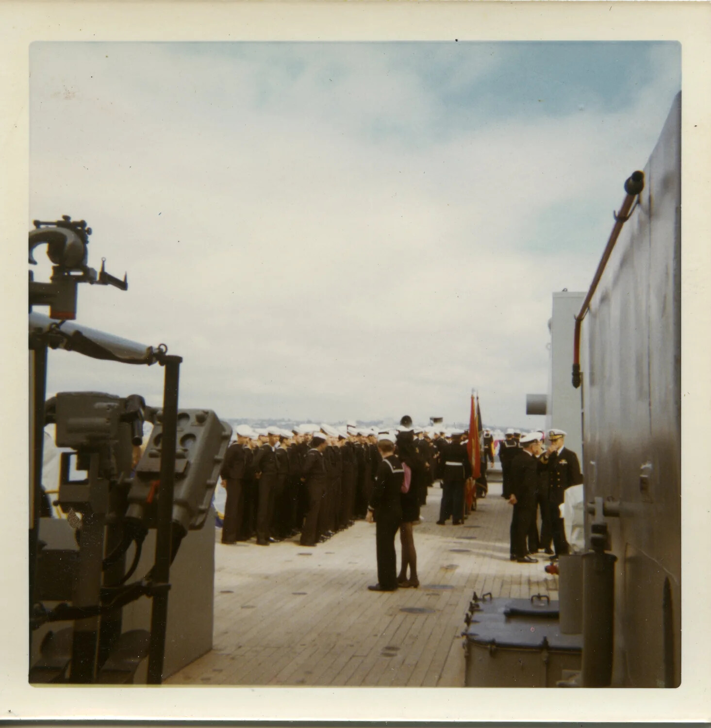 Ship's Company Mustered on Deck with Color Guard Aboard USS Saint Paul (CA-73), circa 1970