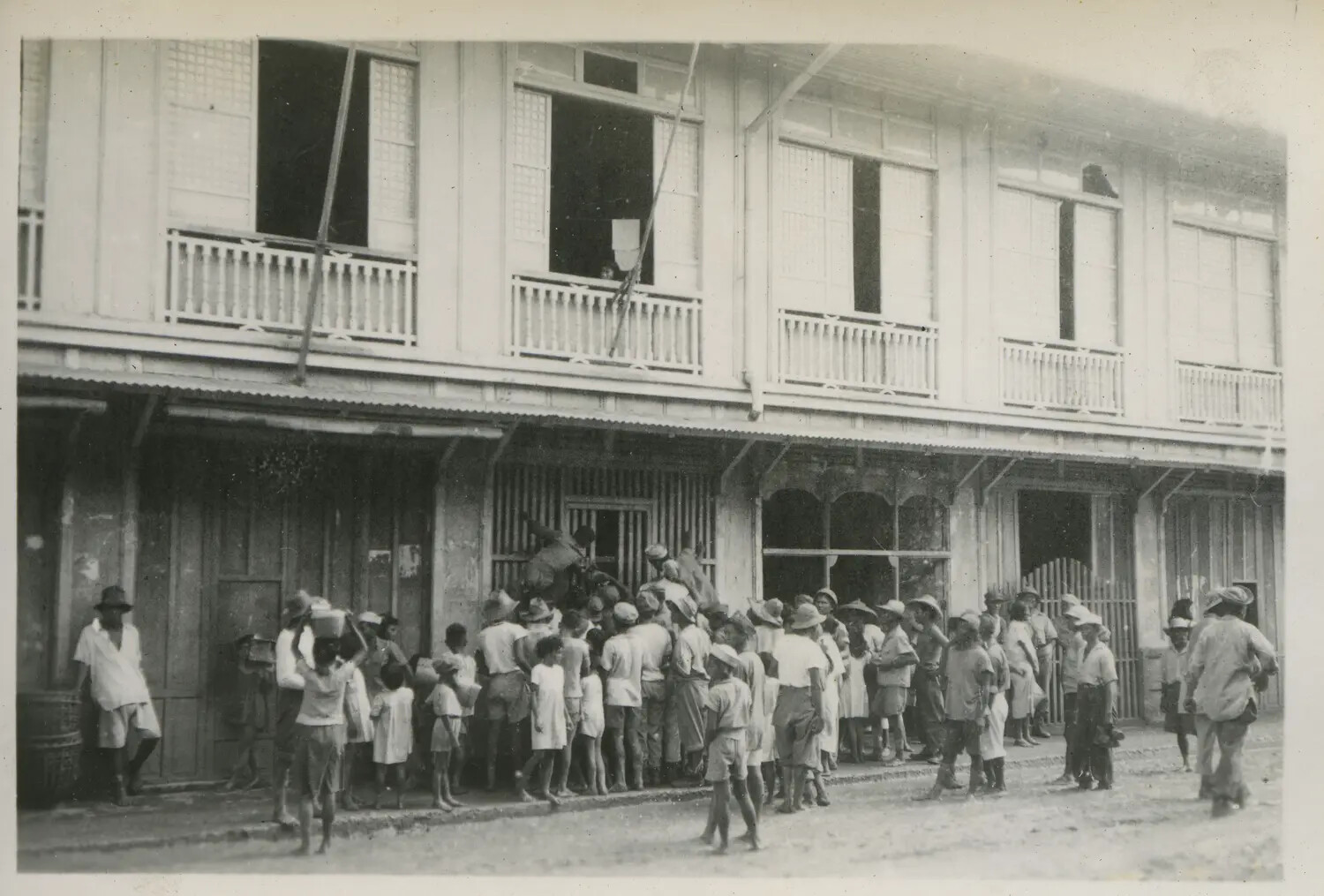 Filipino Civilians Gathered Outside a Colonial-Style Building, Philippines