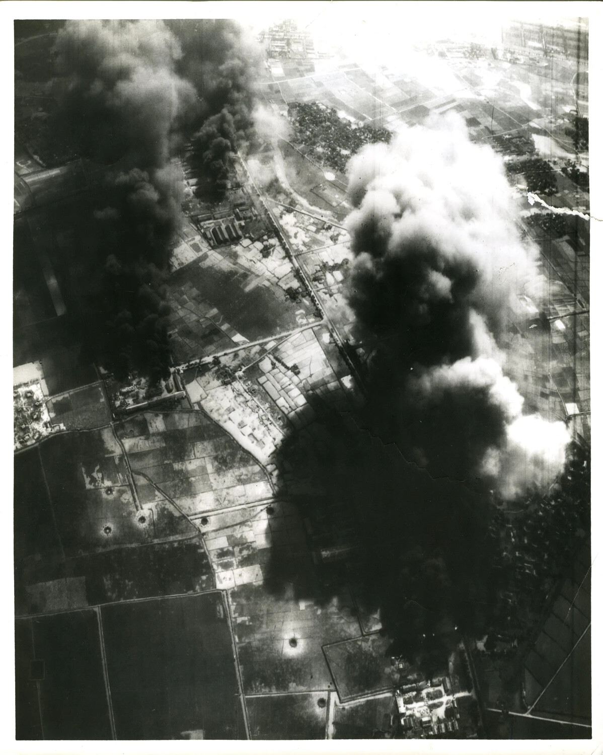 Aerial Strike Photograph: Bombing Smoke and Craters Over Target Area, Vietnam War