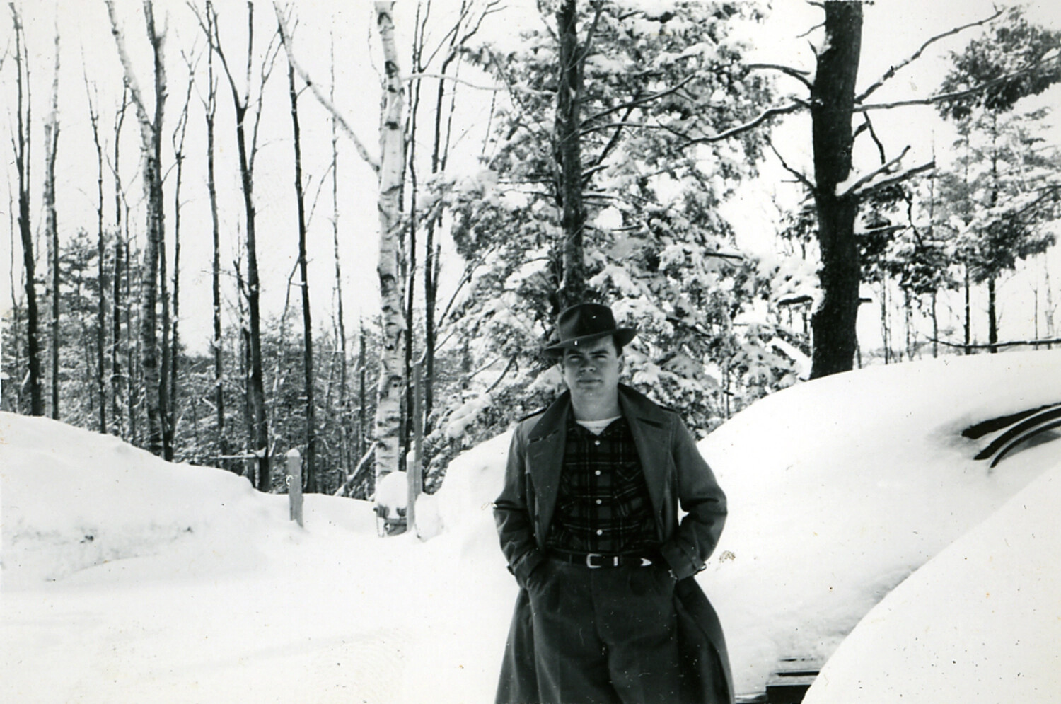 Young Man in Overcoat and Fedora Standing in Deep Snow, Personal Snapshot (Photo Album, Postwar Era)