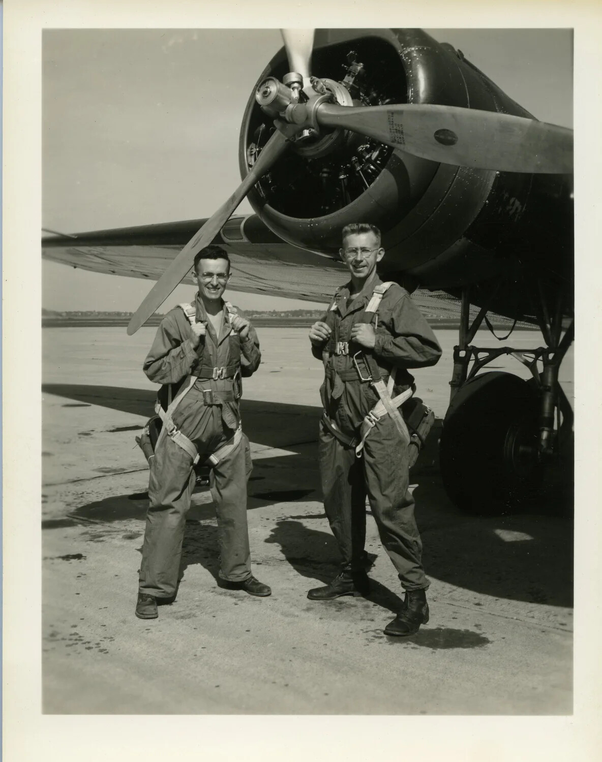 Two Aircrew in Parachute Harnesses Beside Radial-Engine Aircraft -- 'Aerial Camera Test,' CBI Theater