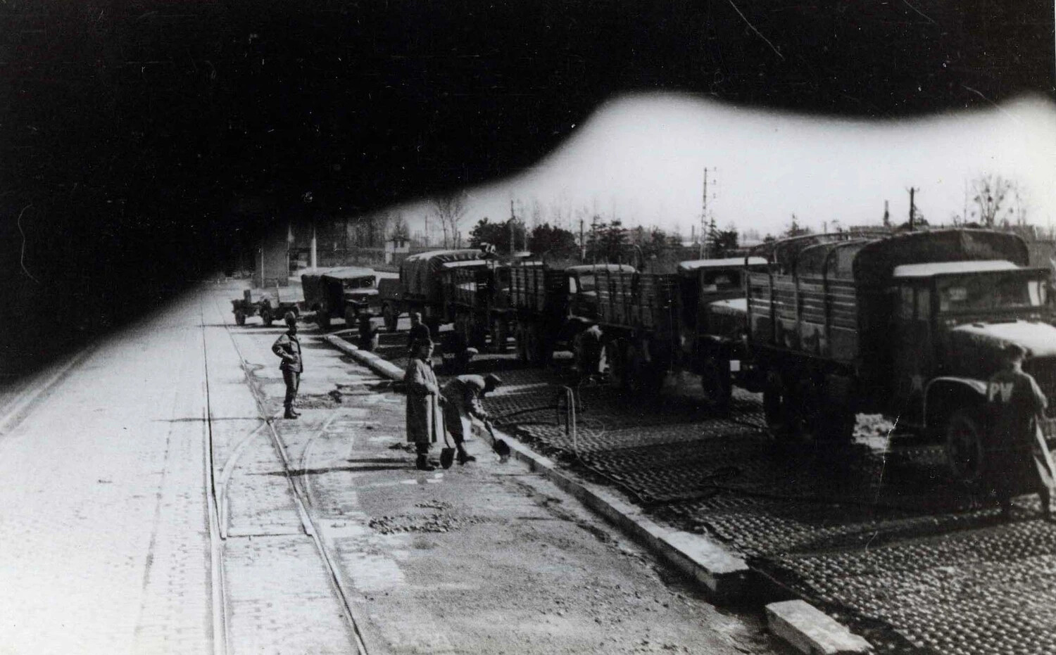 Military Convoy and Street-Clearing Detail on European Cobblestone Street, 101st Airborne Division Collection, World War II
