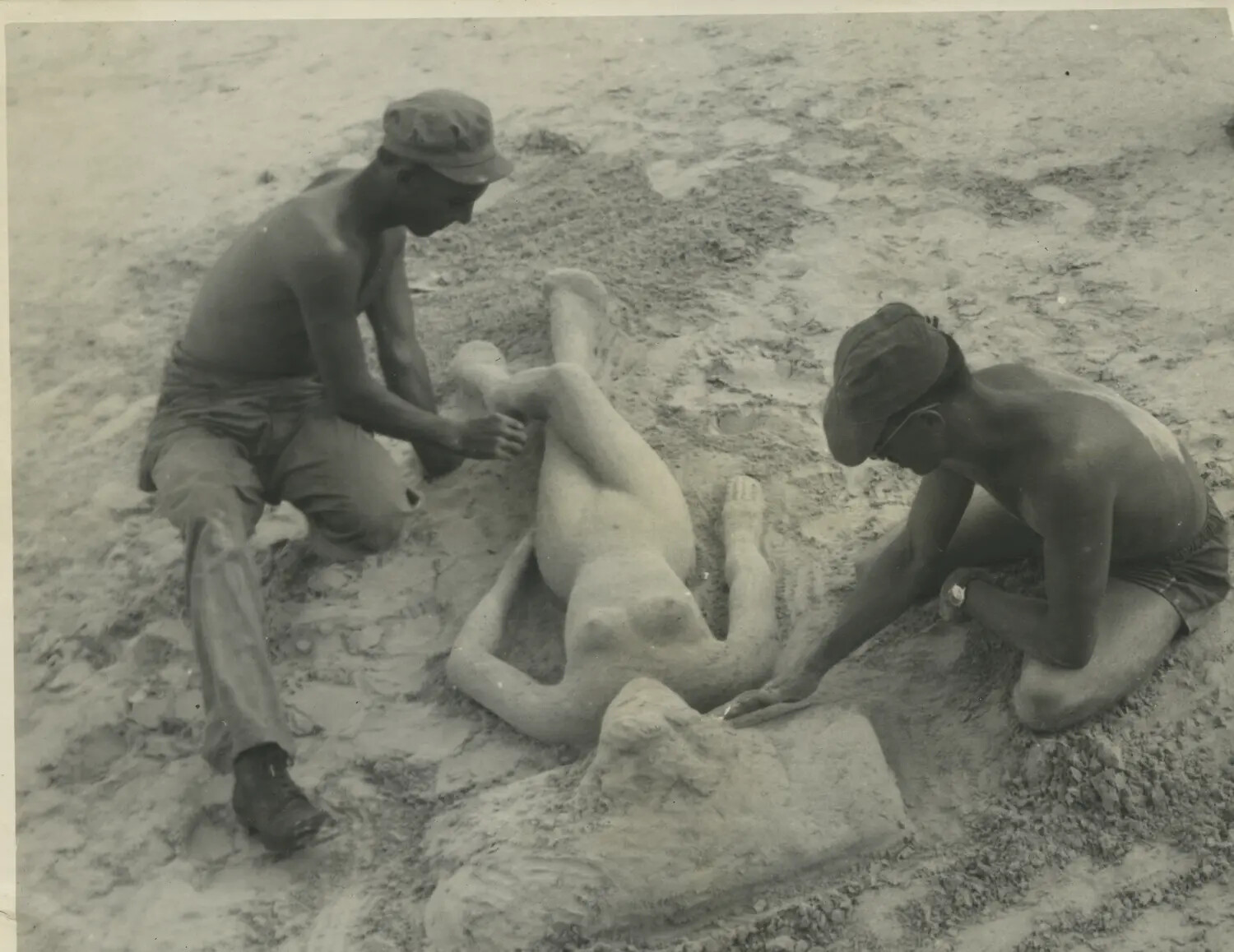 Servicemen Sculpting a Sand Figure on a Pacific Base Beach