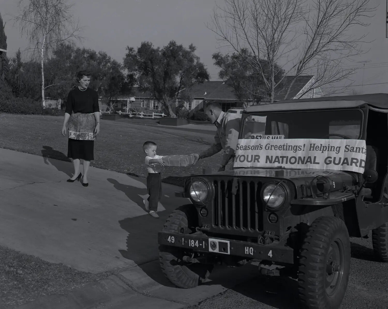 National Guard M38A1 Jeep Christmas Toy Delivery, Suburban Residence, c. late 1950s (Frame 4)