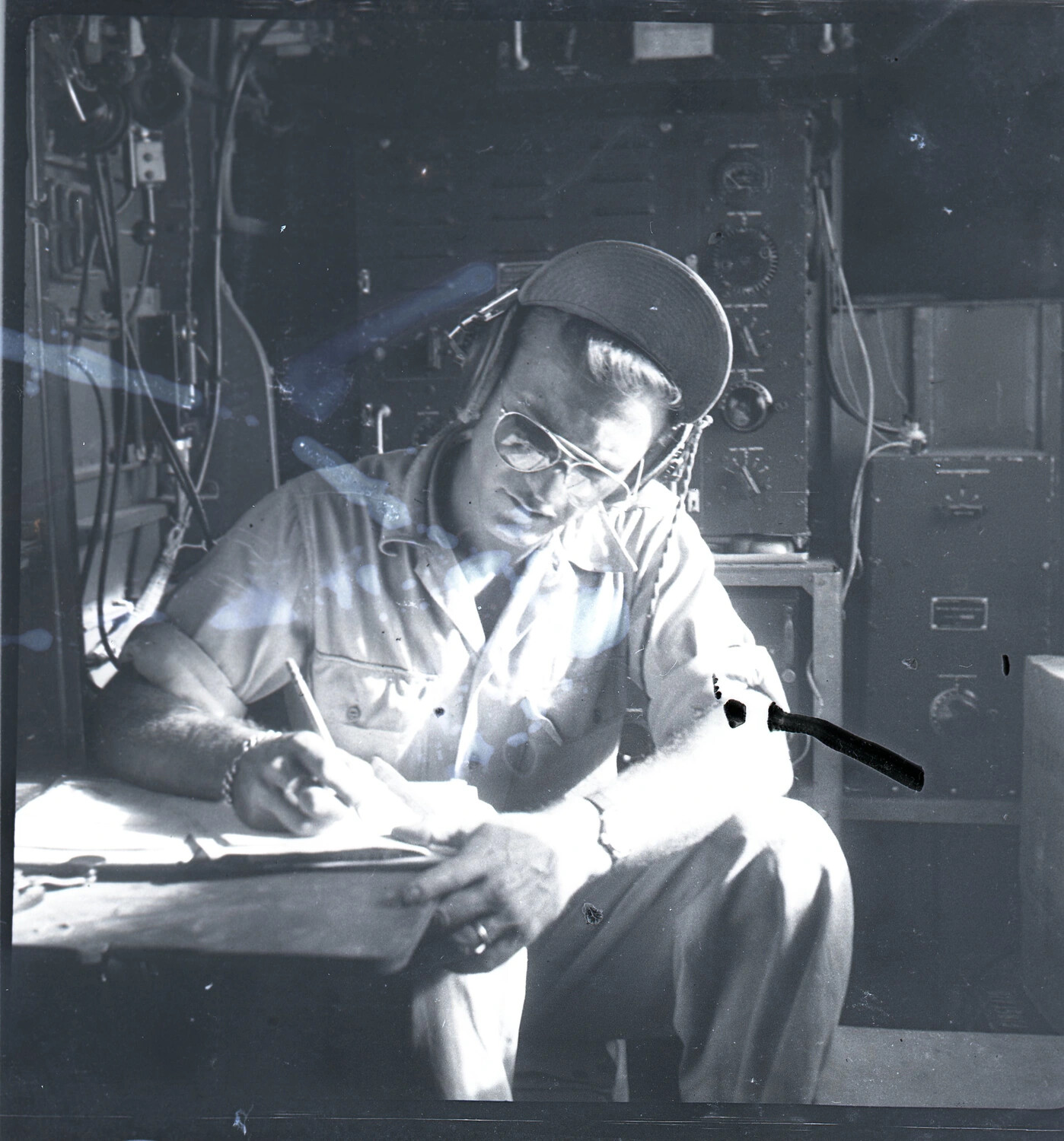 Radio Operator Logging Communications at Equipment Station