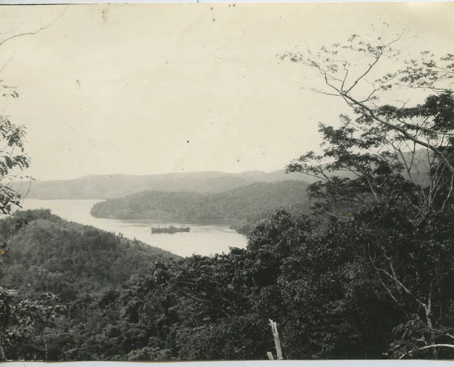 Overlook View of Anchored Supply Ship in Tropical Harbor, Pacific Theater