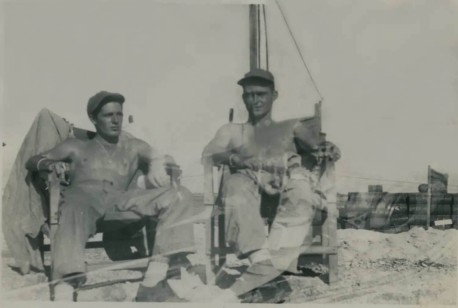 Two Servicemen Relaxing at a Sandy Forward Base, WWII/Korea-Era Personal Photograph