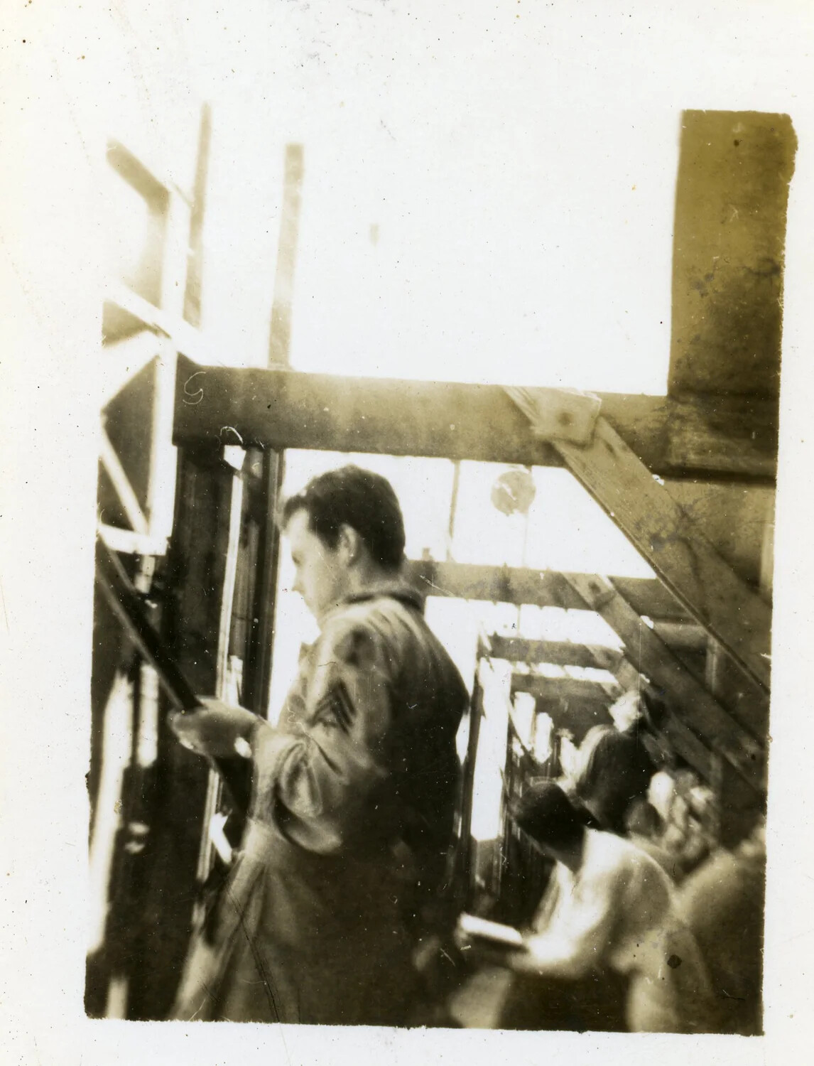 Airmen Inside a Wood-Framed Barracks or Hangar Under Construction