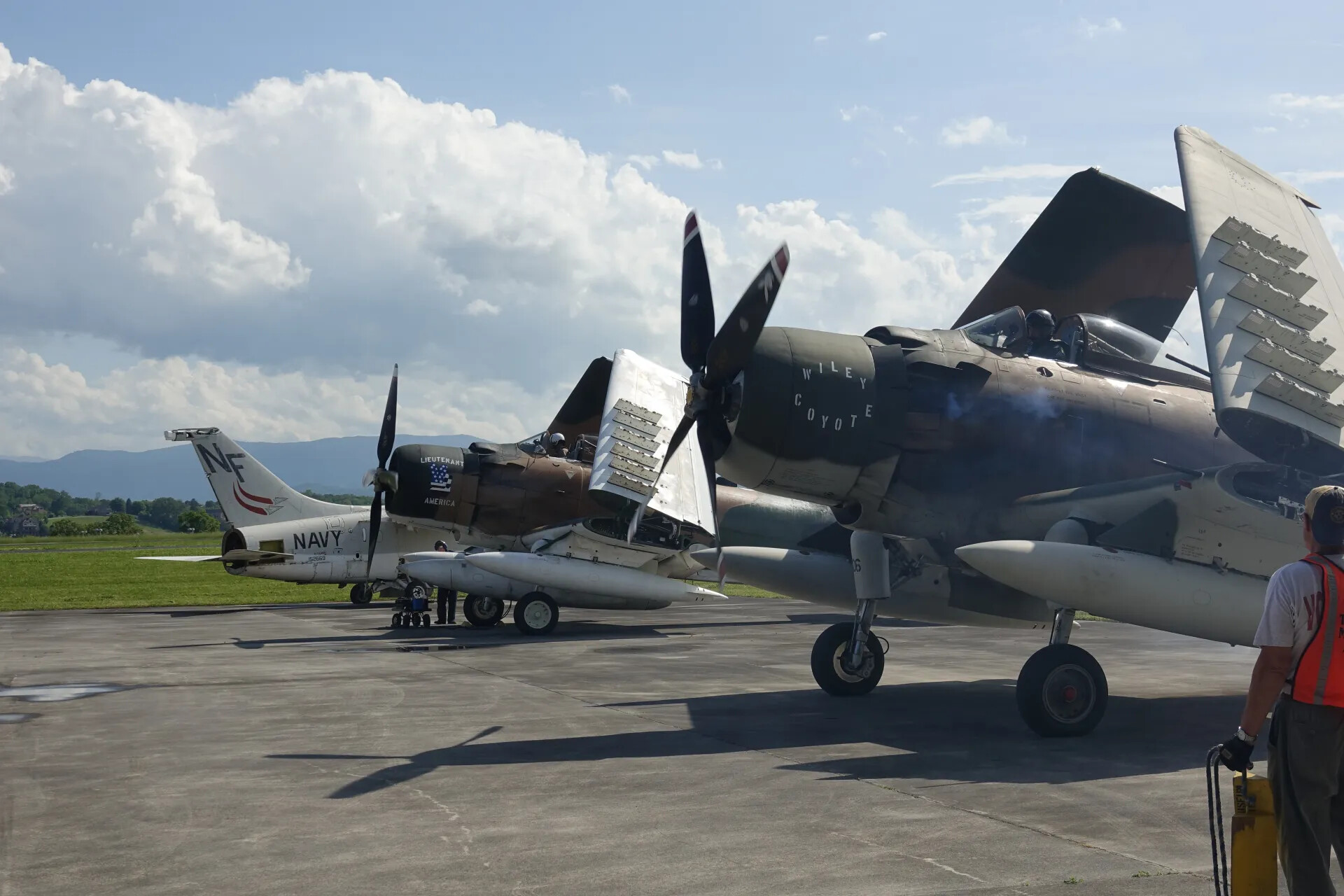 Two Douglas A-1 Skyraiders on the Ramp, 'Wiley Coyote' and Navy-Marked 'Lieutenant America,' May 2019