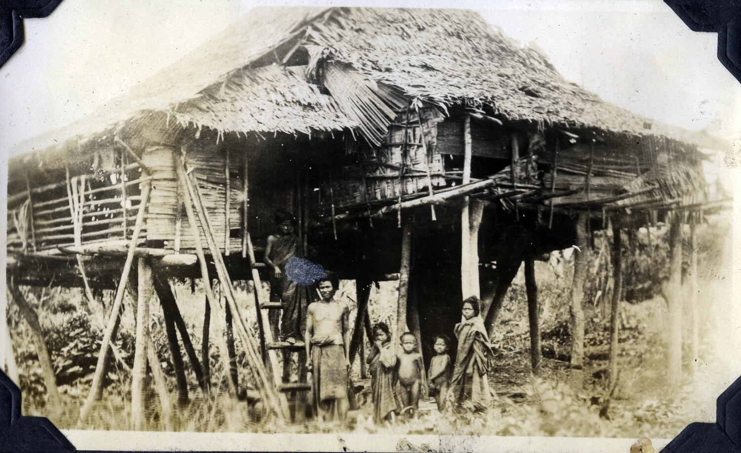 Traditional Stilt House with Family, Rural Philippines, Early 20th Century