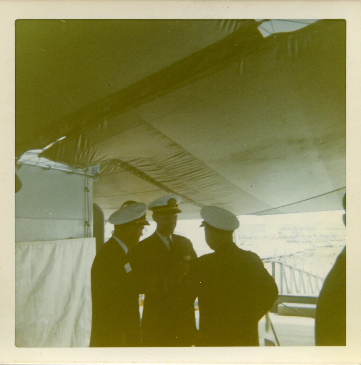 Naval Officers Conferring Beneath Ceremonial Awning Aboard USS Saint Paul (CA-73), circa 1970