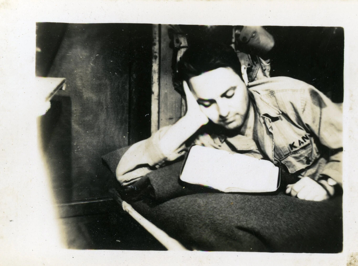 Serviceman 'Kane' Reading on Bunk, World War II Era