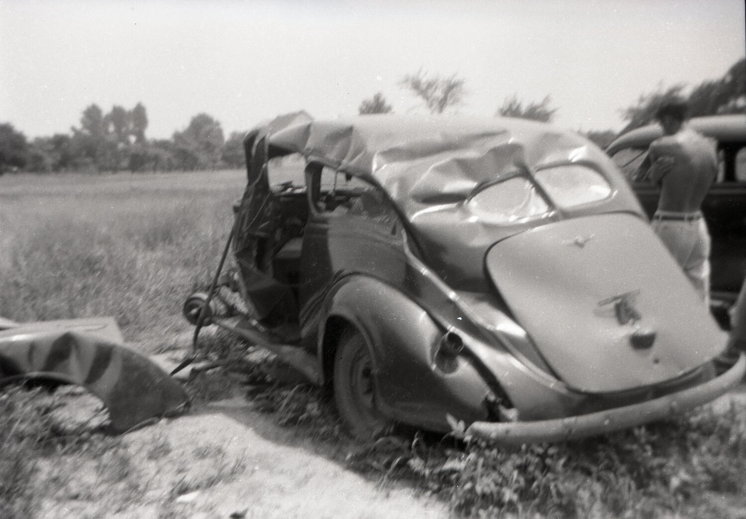 Wrecked 1930s Coupe in Rural Salvage Yard, Rear Three-Quarter View