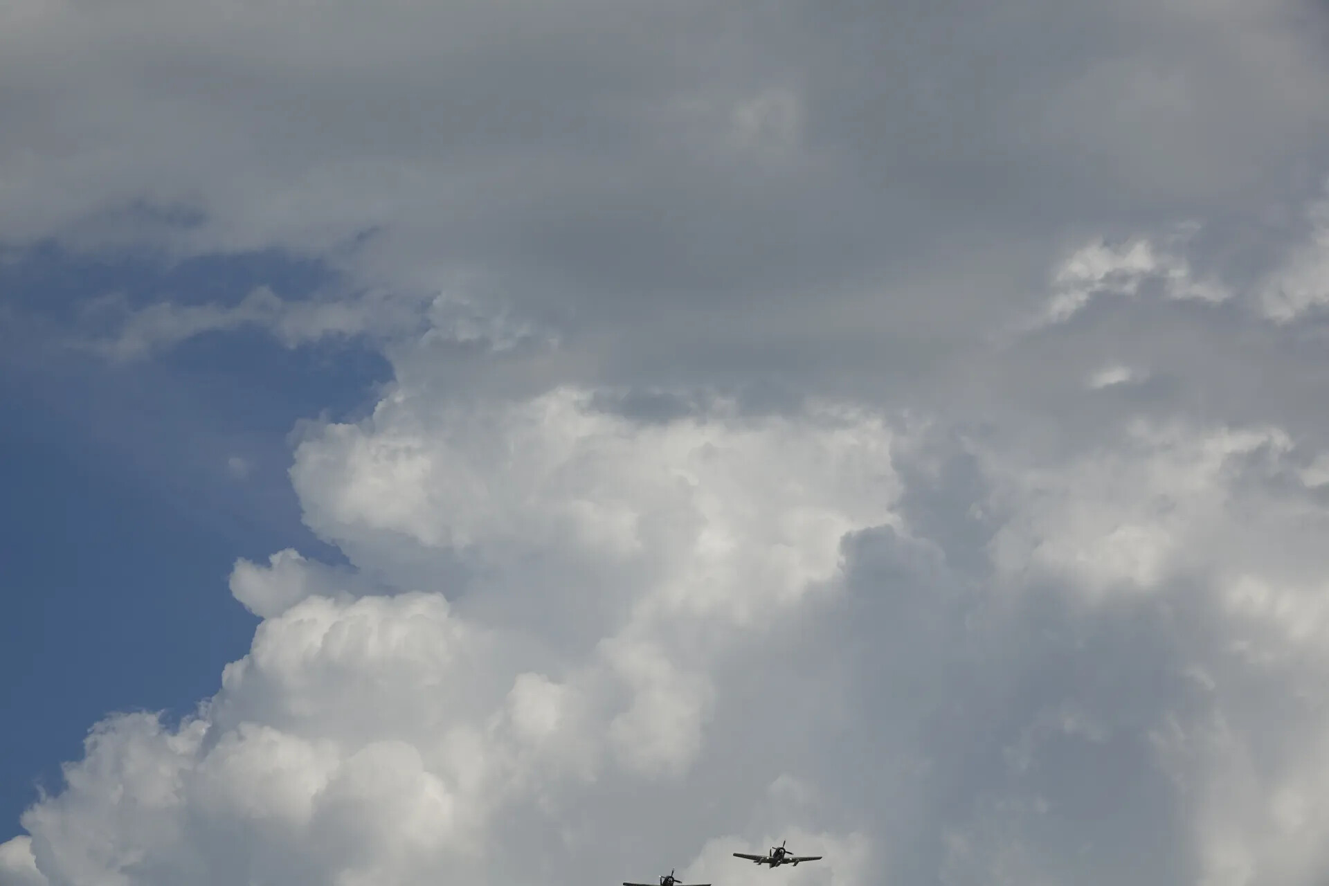 Formation Pass Beneath Towering Cumulus Cloud Bank